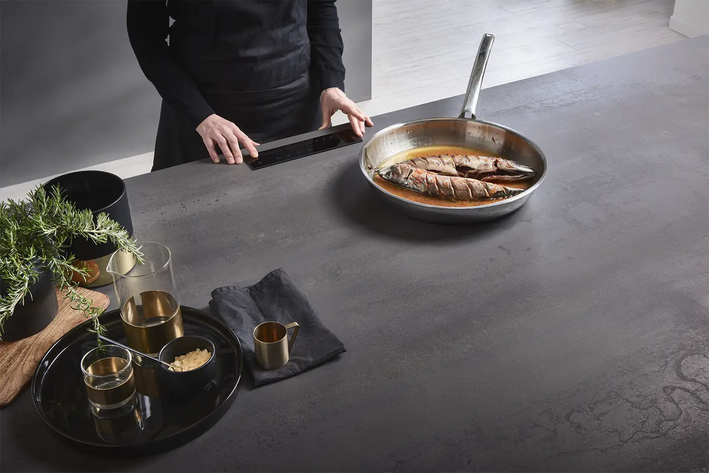 Infinity porcelain countertop with invisible induction: pan heating directly on the seamless slab surface